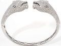 17301 -  An 18 karat white gold panther bangle with round brilliant cut diamonds totaling 6.94 carats.