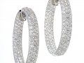 17394 - A pair of 18 karat white gold in and out style hoop earrings pave set with round brilliant cut diamonds totaling 9.77 carats.