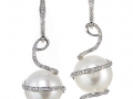 18156 - A pair of 18 karat white gold south sea pearl earrings with round brilliant cut diamonds totaling 0.63 carats.