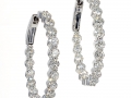 20508 - A pair of 18 karat white gold in and out style hoop earrings with round brilliant cut diamonds totaling 5.05 carats.