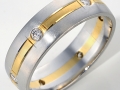 10518 -  A platinum and 18 karat yellow gold band with 0.24 carats of round brilliant cut diamonds.