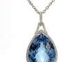 19611 - An 18 karat white gold pendant with a 21.85 carat blue topaz with round brilliant cut diamonds totaling 0.29 carats.