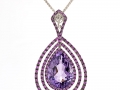 19952 - A 14 karat white gold pendant with a 6.00 carat pear shape amethyst and 0.83 carats of pink sapphires.