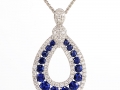19994 - A 14 karat white gold pendant with sapphires totaling 1.20 carats and 0.55 carats of round brilliant cut diamonds.