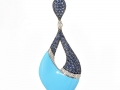 20398 - A 14 karat white gold turquoise pendant with sapphires totaling 2.08 carats and round brilliant cut diamonds totaling 0.21 carats.