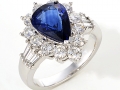 12364 - An 18 karat white gold ring with a 3.01 carat pear shape sapphire surrounded by round brilliant cut and tapered baguette cut diamonds that total 1.44 carats.