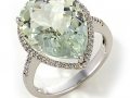 12518 - A 18 karat white gold ring with a pear shape 7.71 carat green amethyst and round brilliant cut diamonds totaling 0.16 carats.