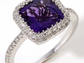 13039 - A 14 karat white gold ring with a cushion brilliant cut amethyst weighing 1.79 carats and round brilliant cut diamonds totaling 0.39 carats.
