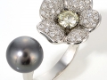 16646 - An 18 karat white gold tahitian pearl ring with a champagne diamond weighing 0.60 carats and round brilliant cut diamonds totaling 0.68 carats.