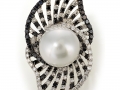 19844 - An 18 karat white gold ring set with a south sea pearl and white and black round brilliant cut diamonds totaling 3.69 carats.